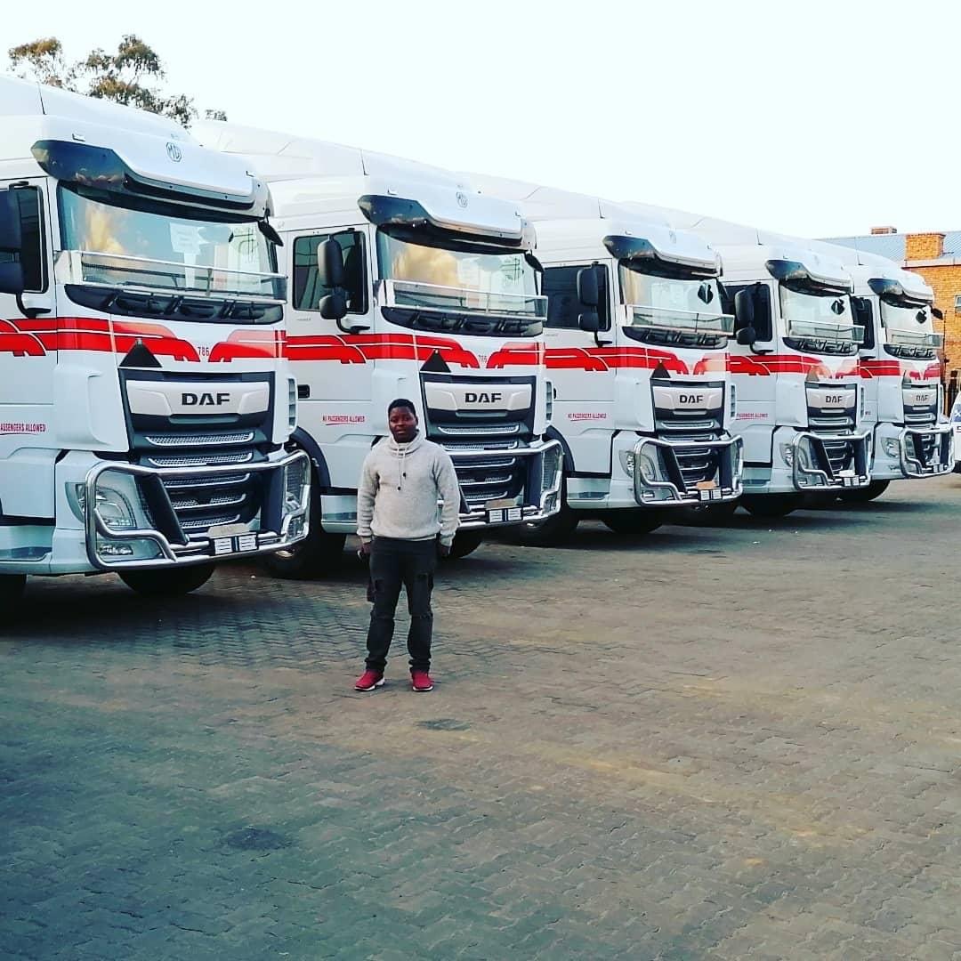 Fleet of DAF commercial trucks with matching red and white corporate livery